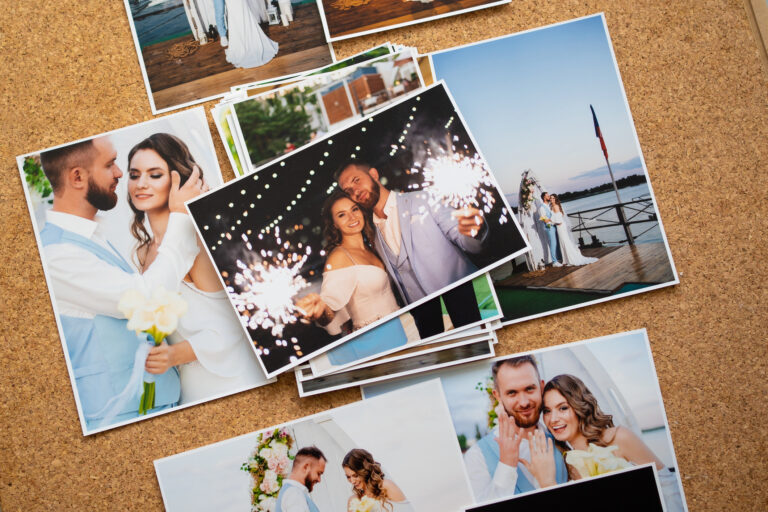 Several printed copies of wedding photos laying on a surface