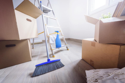 Cleaning supplies sit in a room full of boxes