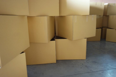 Brown moving boxes stacked up on the floor.
