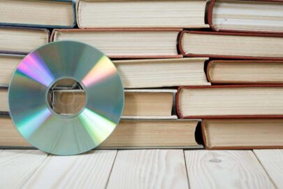 A music CD leaning against stacked books.