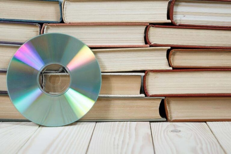 A music CD leaning against stacked books.