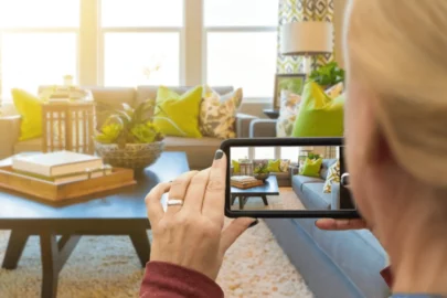 Person taking a photo of a living room.