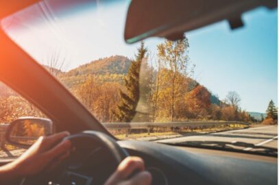 Person driving next to hills.