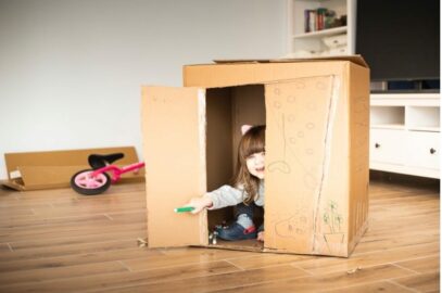 Toddler coloring on a moving box.