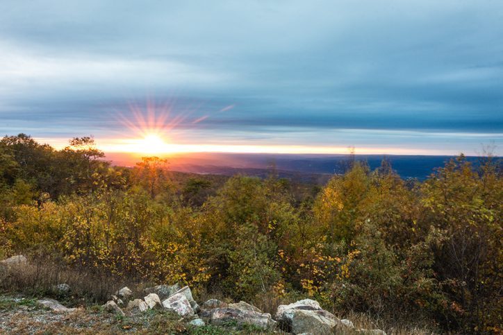 sunset at High Point State Park with trees and grass in foreground