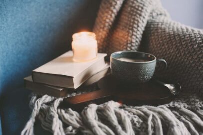 coffee or cocoa, books, warm knitted blanket and in Nordic style chair