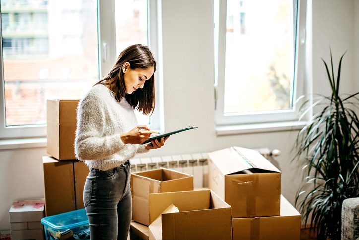 woman looking at moving list