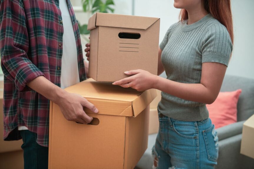 A couple are organizing boxes for storage.