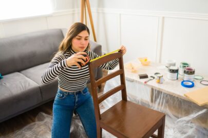 Young woman working on furniture restoration.