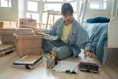 A college student unpacks and gets organized in her dorm room.